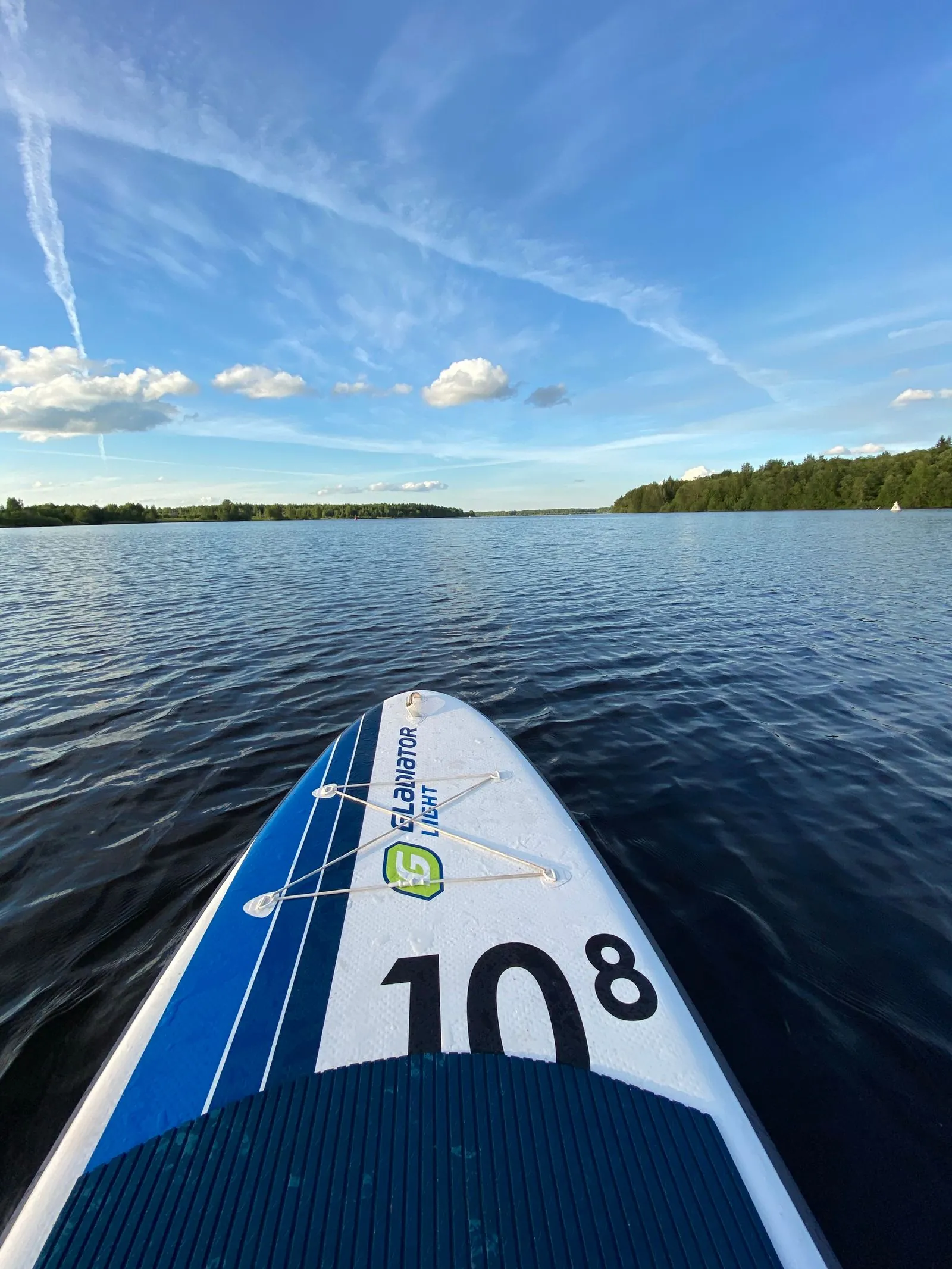 Stand up paddleboarding on calm water near Blue Springs Ranch