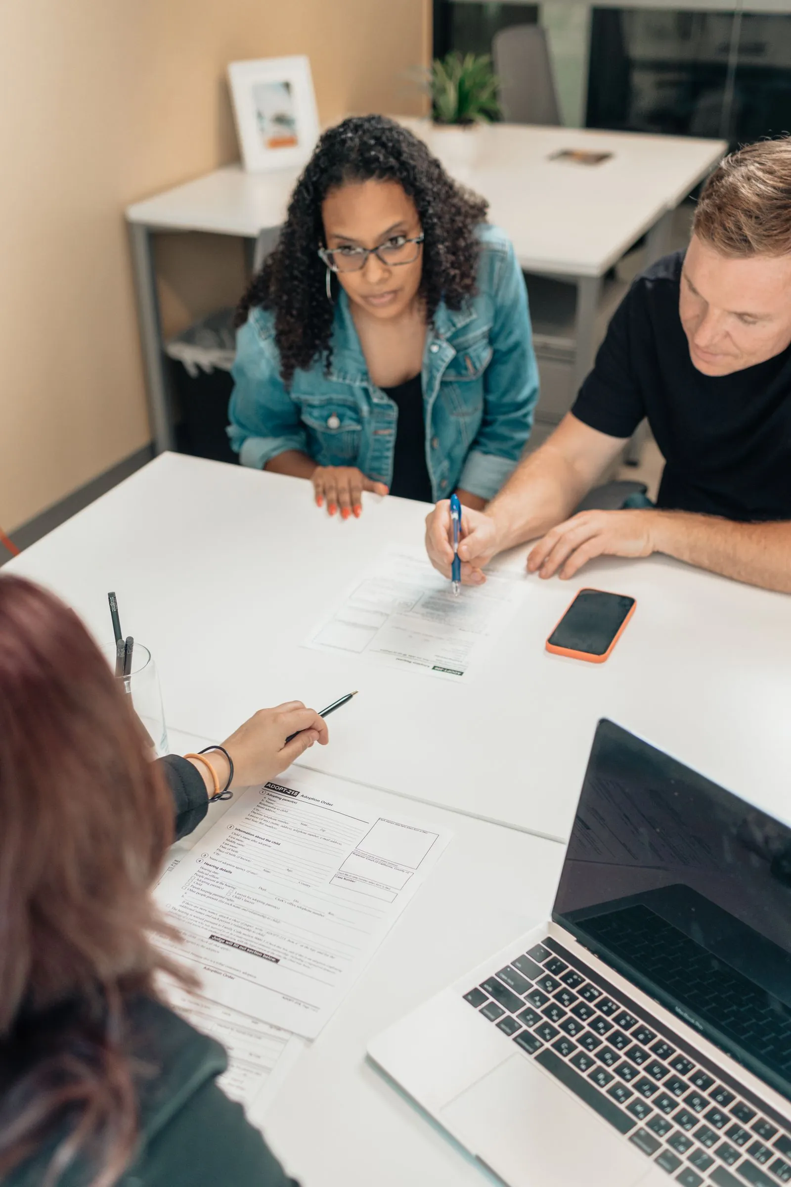 A couple reviewing paperwork together at a bright desk