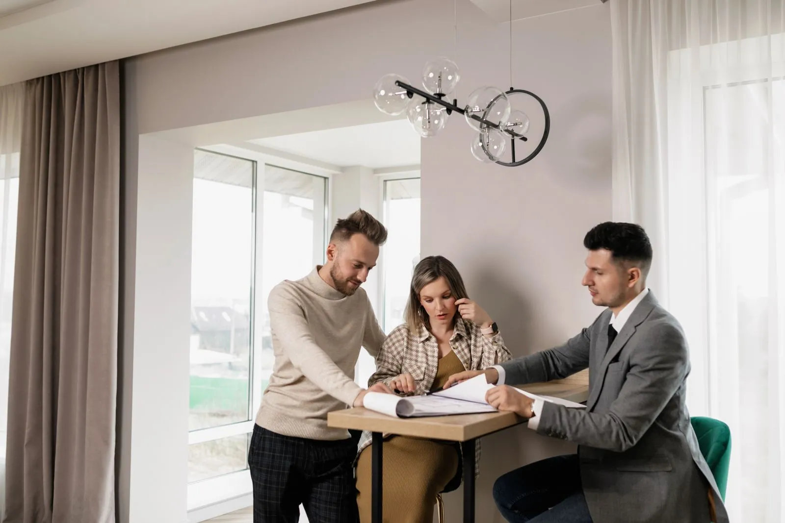 A couple meeting with a land specialist at the closing table